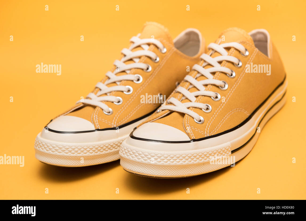 Yellow sneakers on a blue background Stock Photo