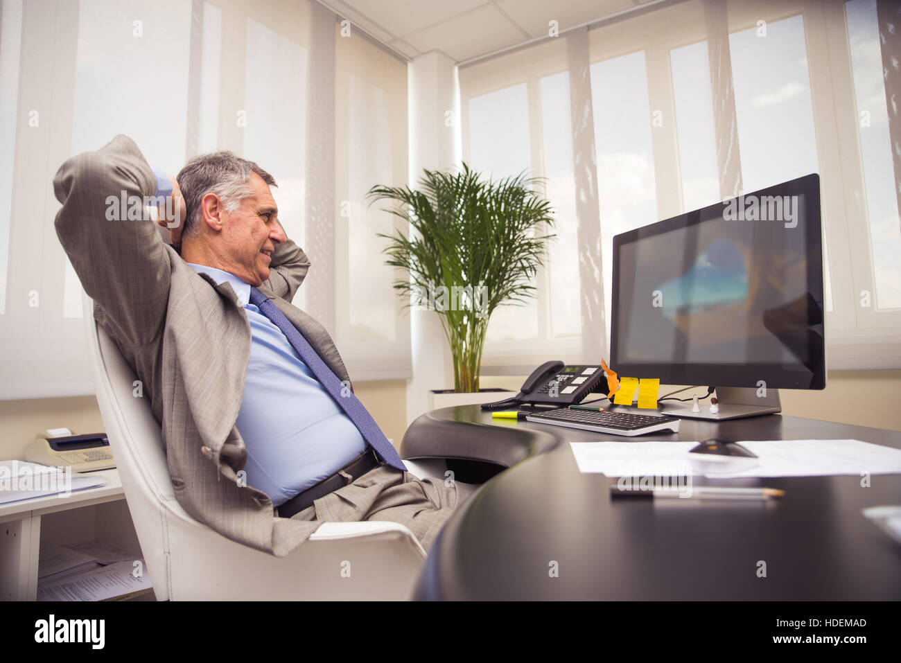 Businessman In Office Relaxing Leaning Back On Chair Stock Photo Alamy