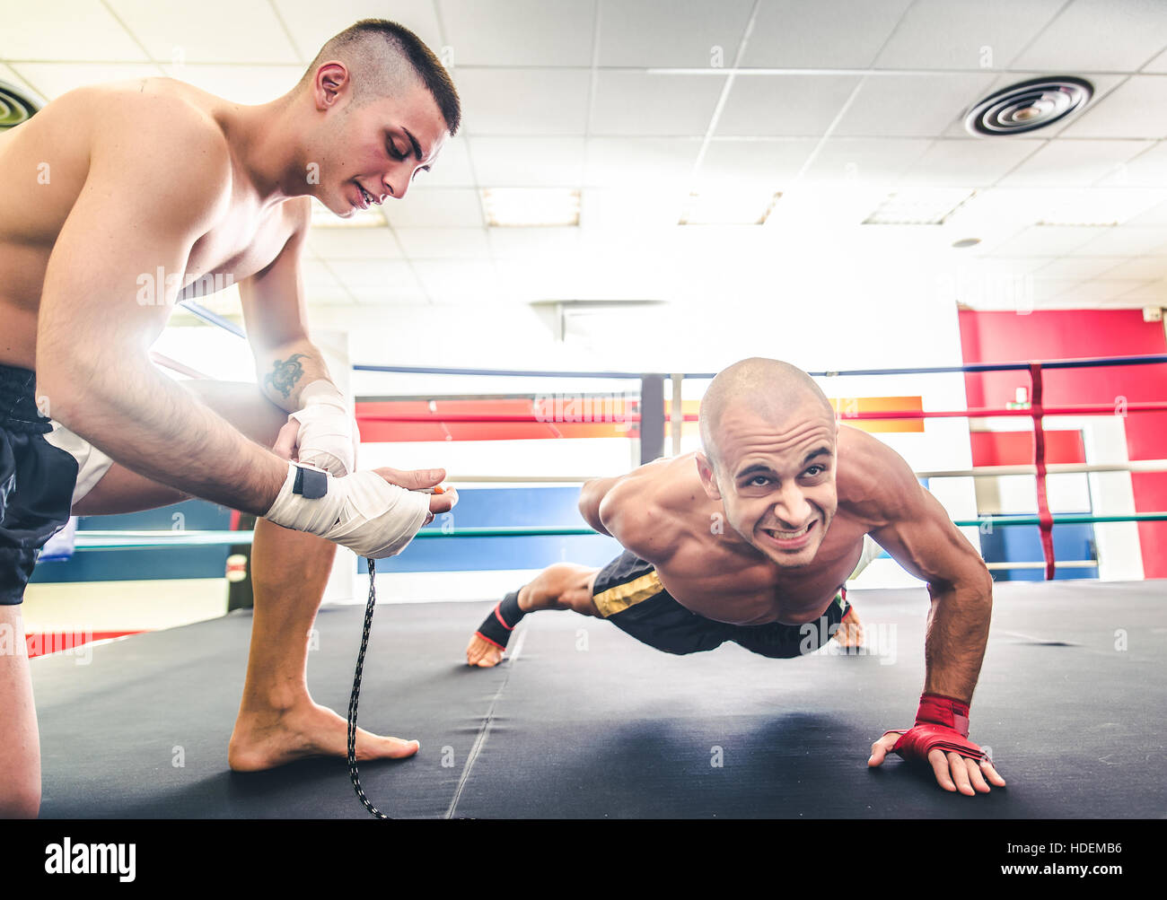 Muay thai fighter doing push ups Coach training his athlete for a