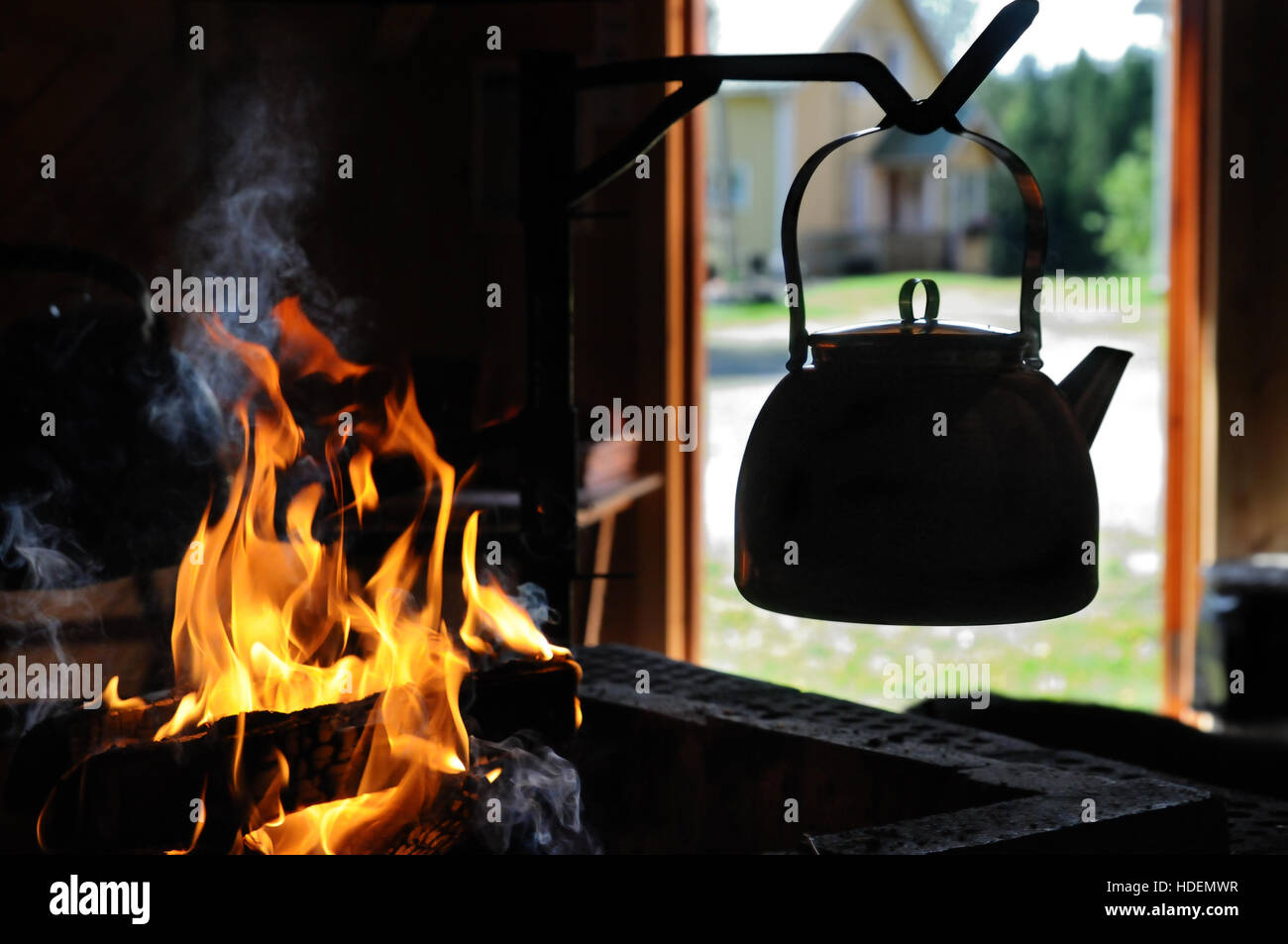 Kettle with water heated on the fire Stock Photo - Alamy