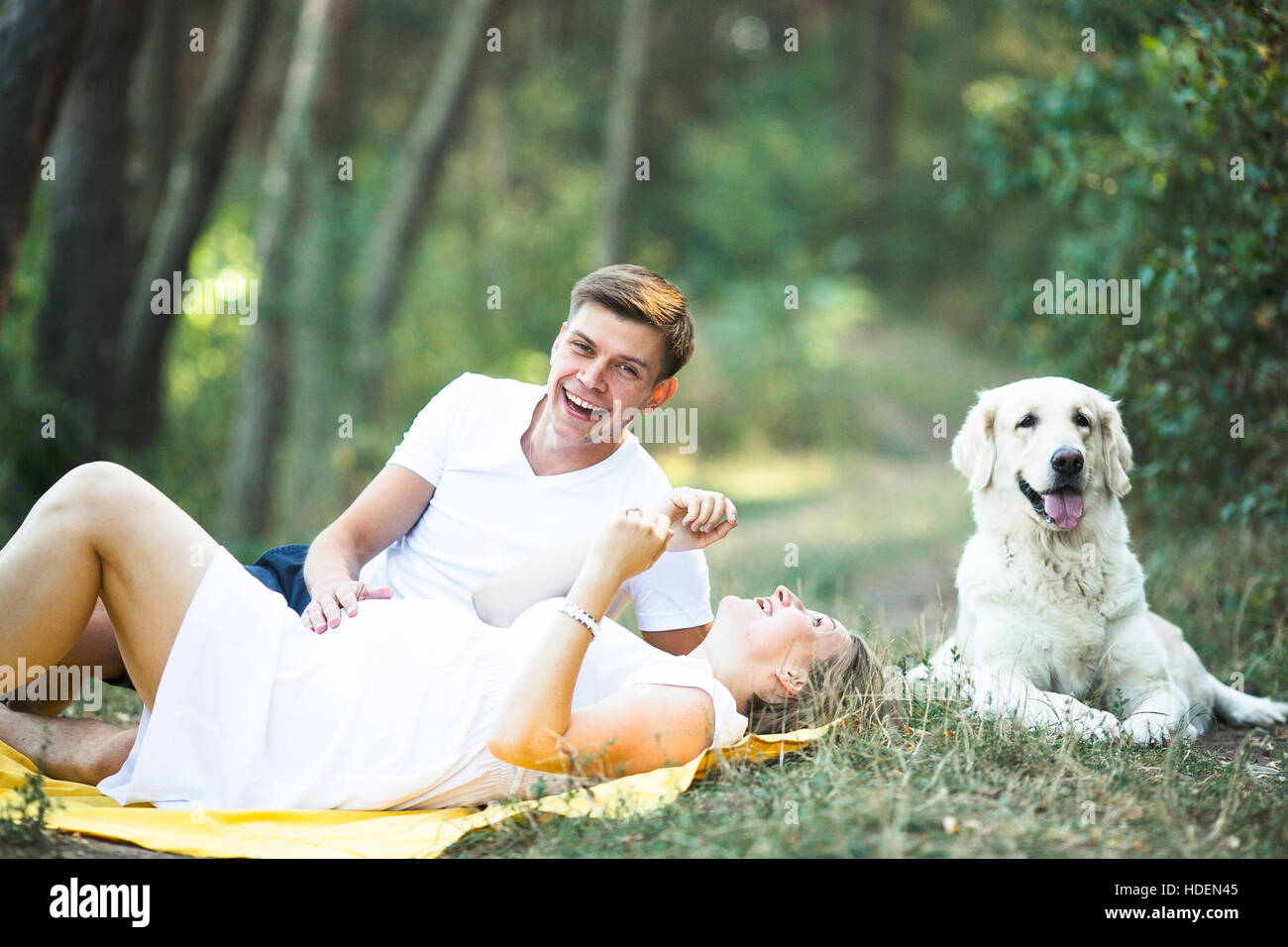 pregnant woman with husband lying in the park Stock Photo - Alamy