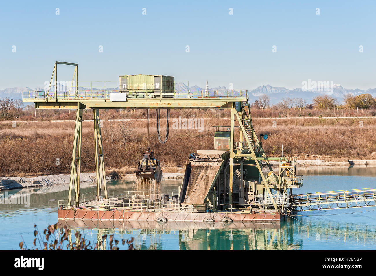 Gravel pit. Technology for extraction of gravel from a quarry filled with water. Stock Photo