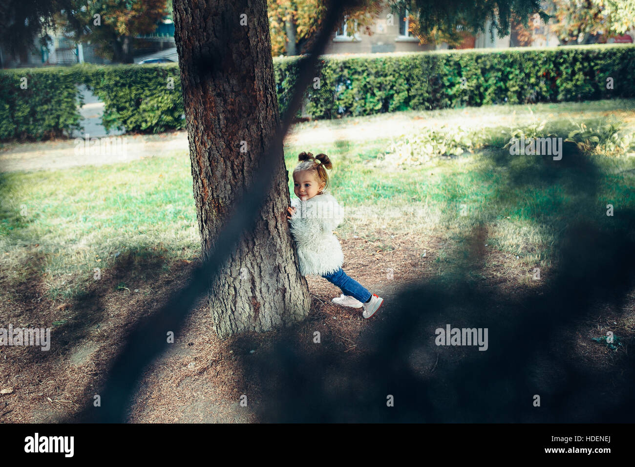 Cute little girl is playing outdoors Stock Photo - Alamy