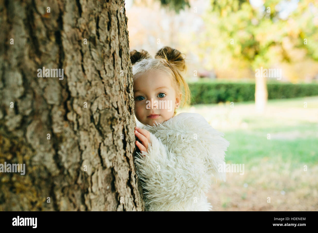 Cute little girl is playing outdoors Stock Photo - Alamy