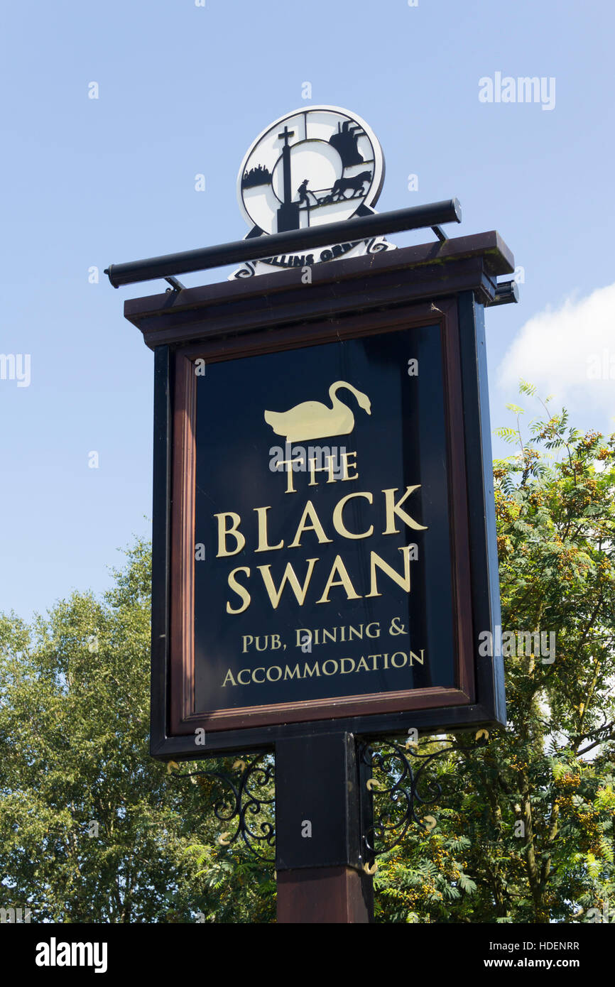 Sign outside the Black Swan pub, restaurant and boutique hotel in the village of Hollins Green, Warrington, Cheshire. Stock Photo