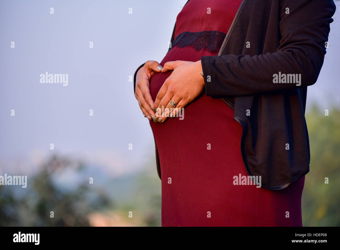 Maternity shoot of an eight month pregnant woman wearing a beautiful