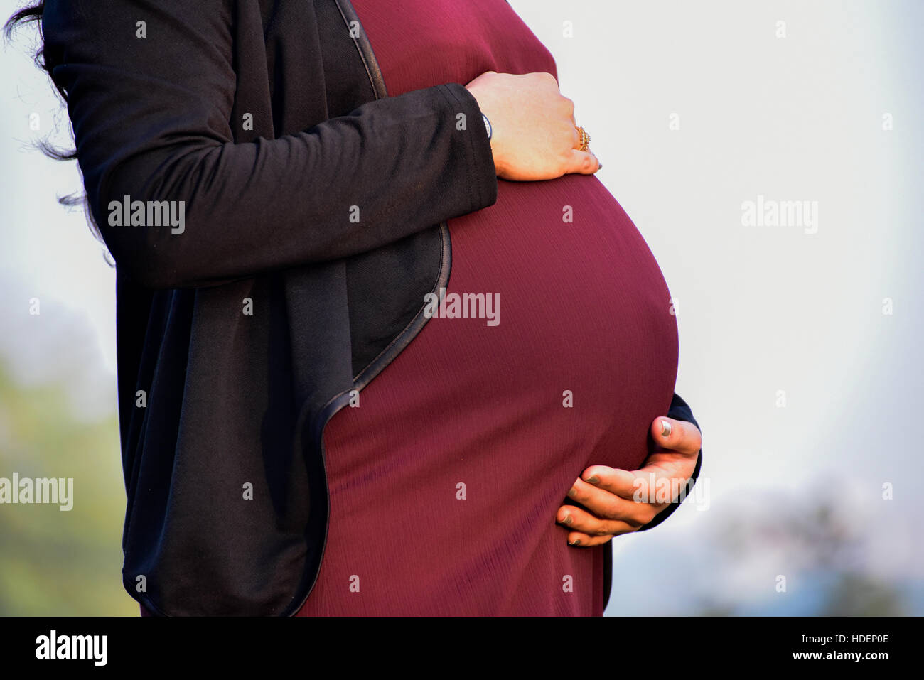 Maternity shoot of an eight month pregnant woman wearing a beautiful