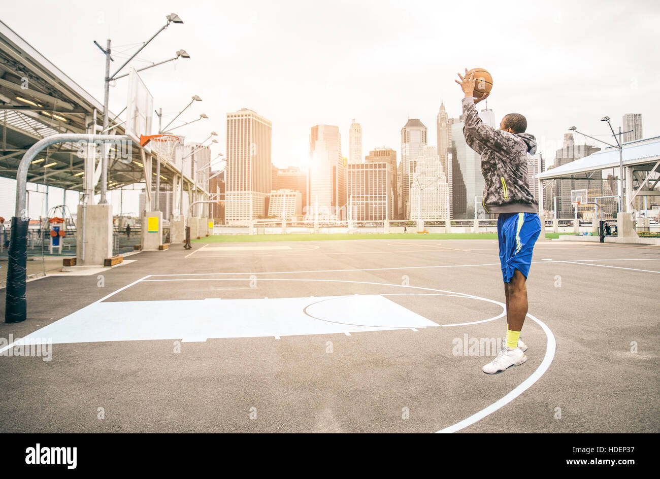 Sportive afro-american man playing  basketball outdoors - Basketball player training on shooting Stock Photo