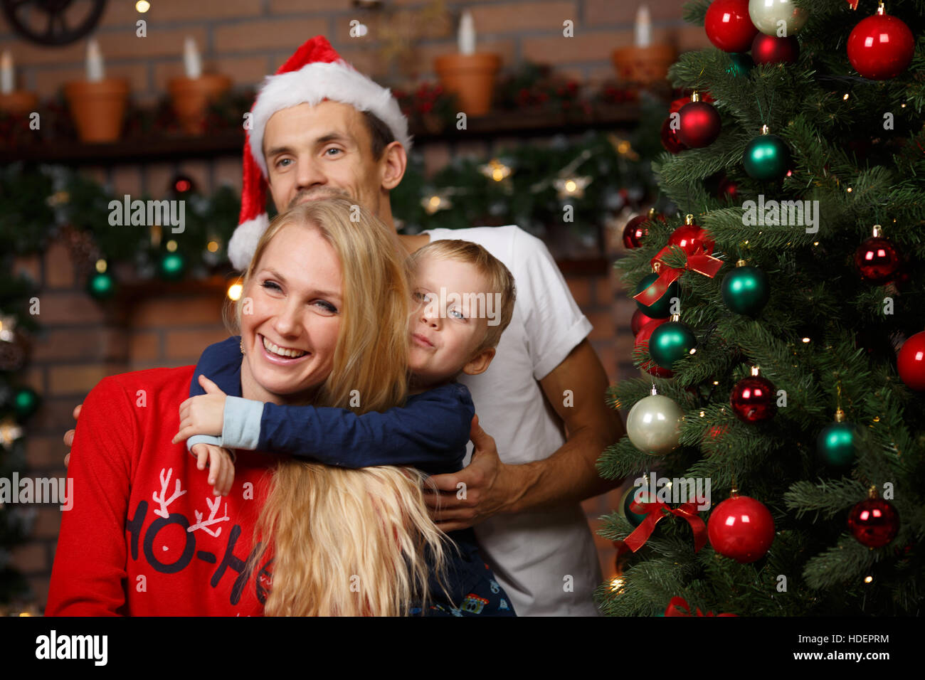 Parents ,son at Christmas tree Stock Photo