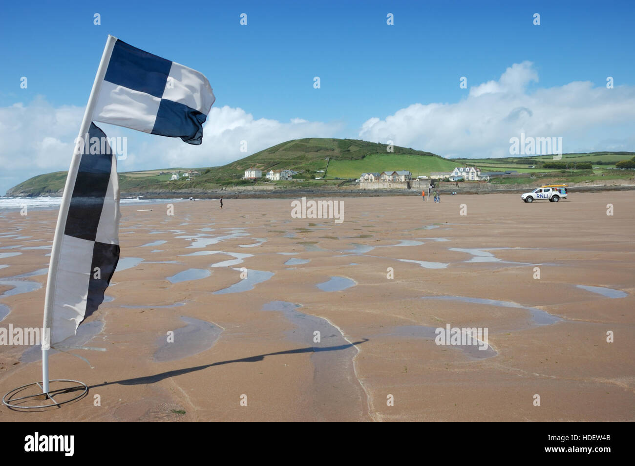 Black and white chequered RNLI beach safety flag flying on Croyde Bay