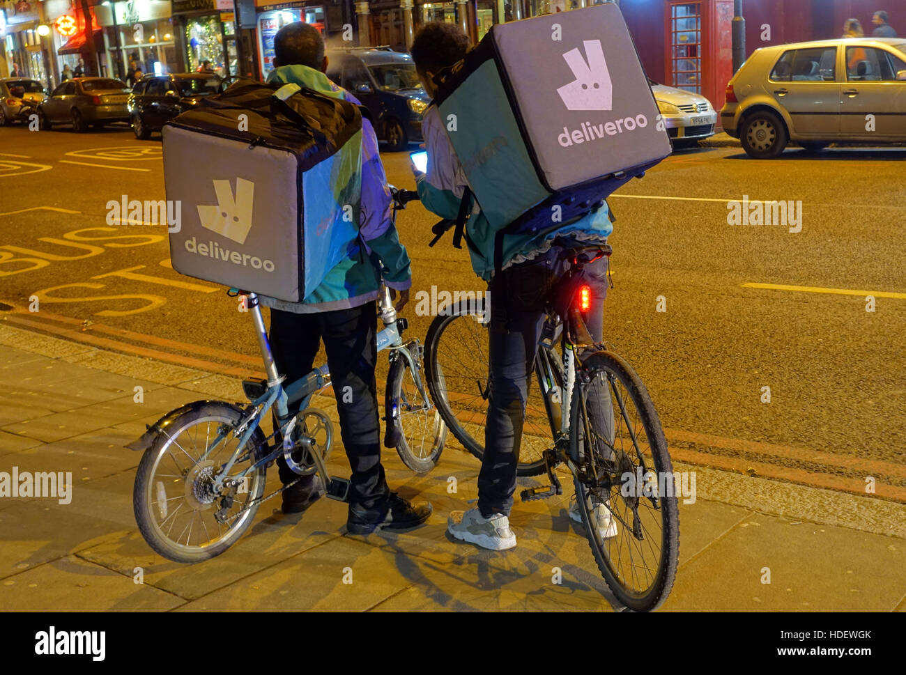 Deliveroo food delivery bicycle couriers in Islington, London Stock Photo