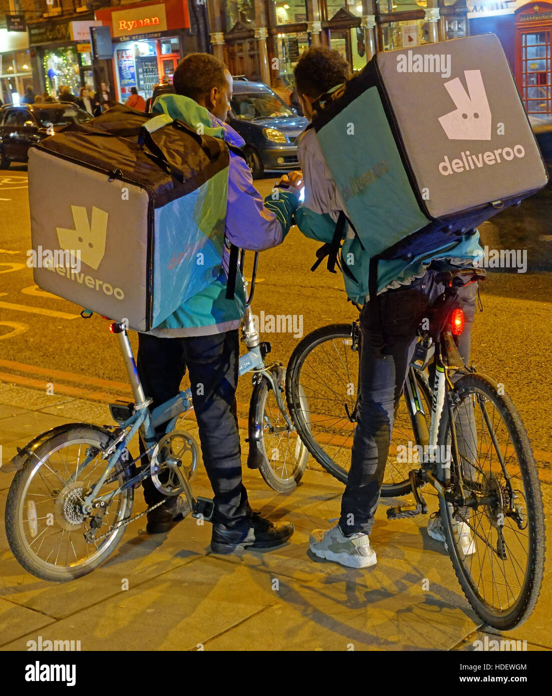 Deliveroo food delivery bicycle couriers in Islington, London Stock Photo