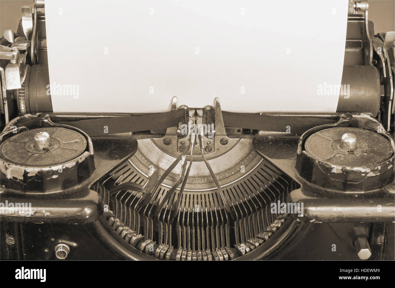 Old typewriter and blank sheet of paper for your text, sepia style Stock Photo