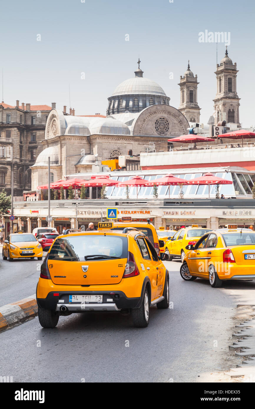 Istanbul, Turkey - July 1, 2016: Yellow taxi cars on the street near Taksim square. Cityscape of Istanbul Stock Photo