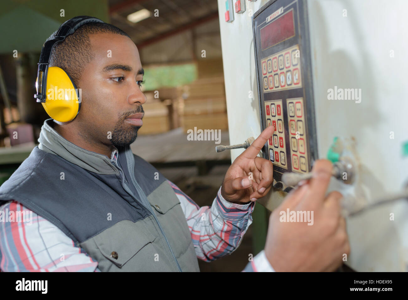 Worker entering code on keypad Stock Photo - Alamy