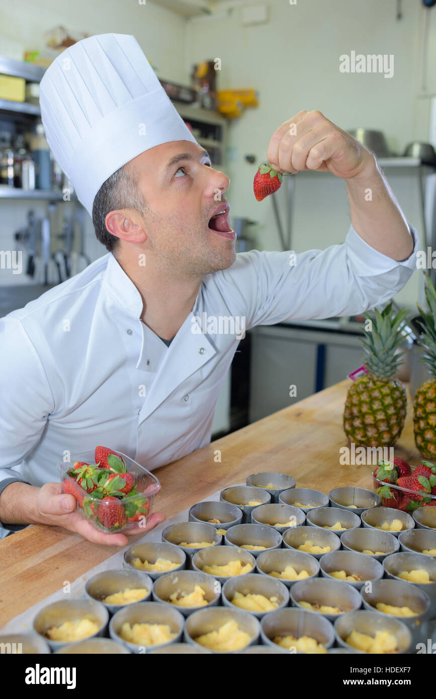pastry chef holding delicious looking cakes and pastries Stock Photo