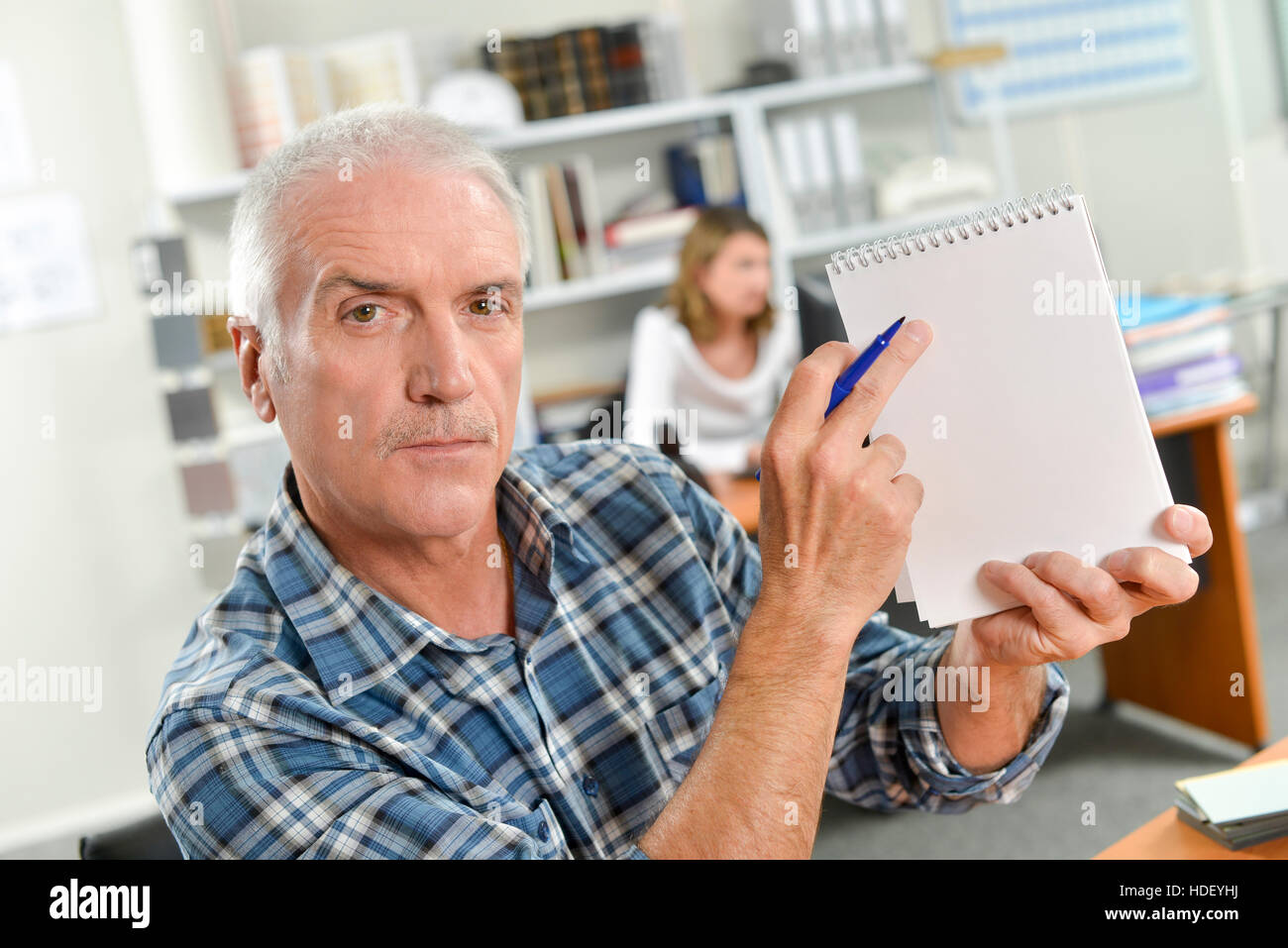 Pointing to a notepad Stock Photo - Alamy