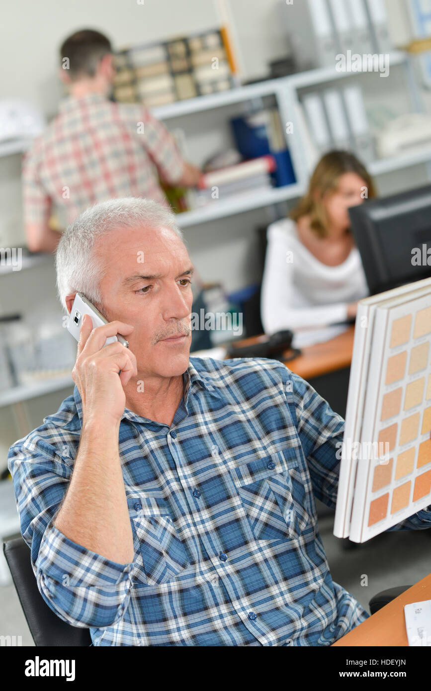 Choosing paint over the phone Stock Photo Alamy