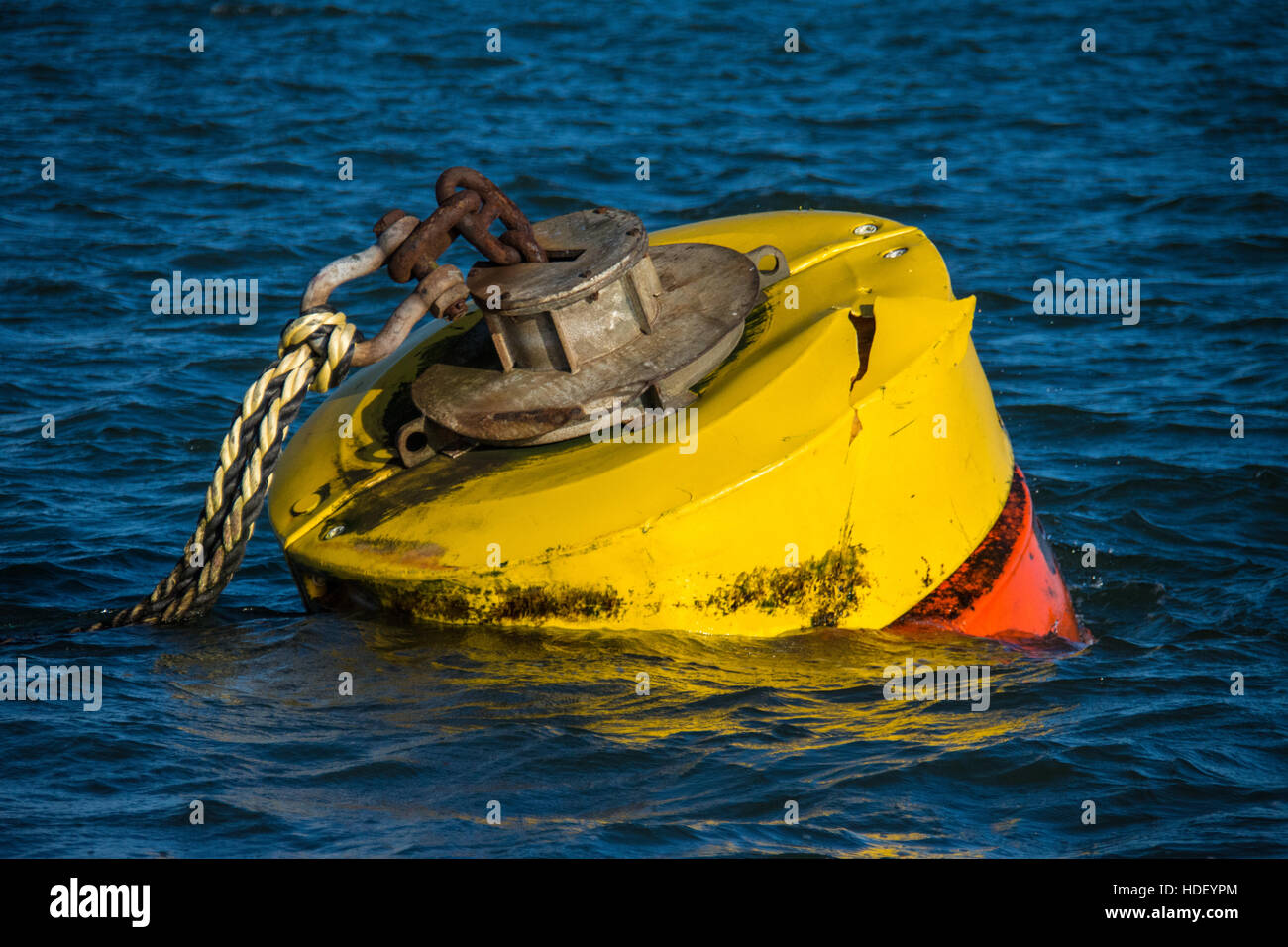 Massive mooring rope on a tug mooring buoy in blue rippled water in Milford Haven Stock Photo