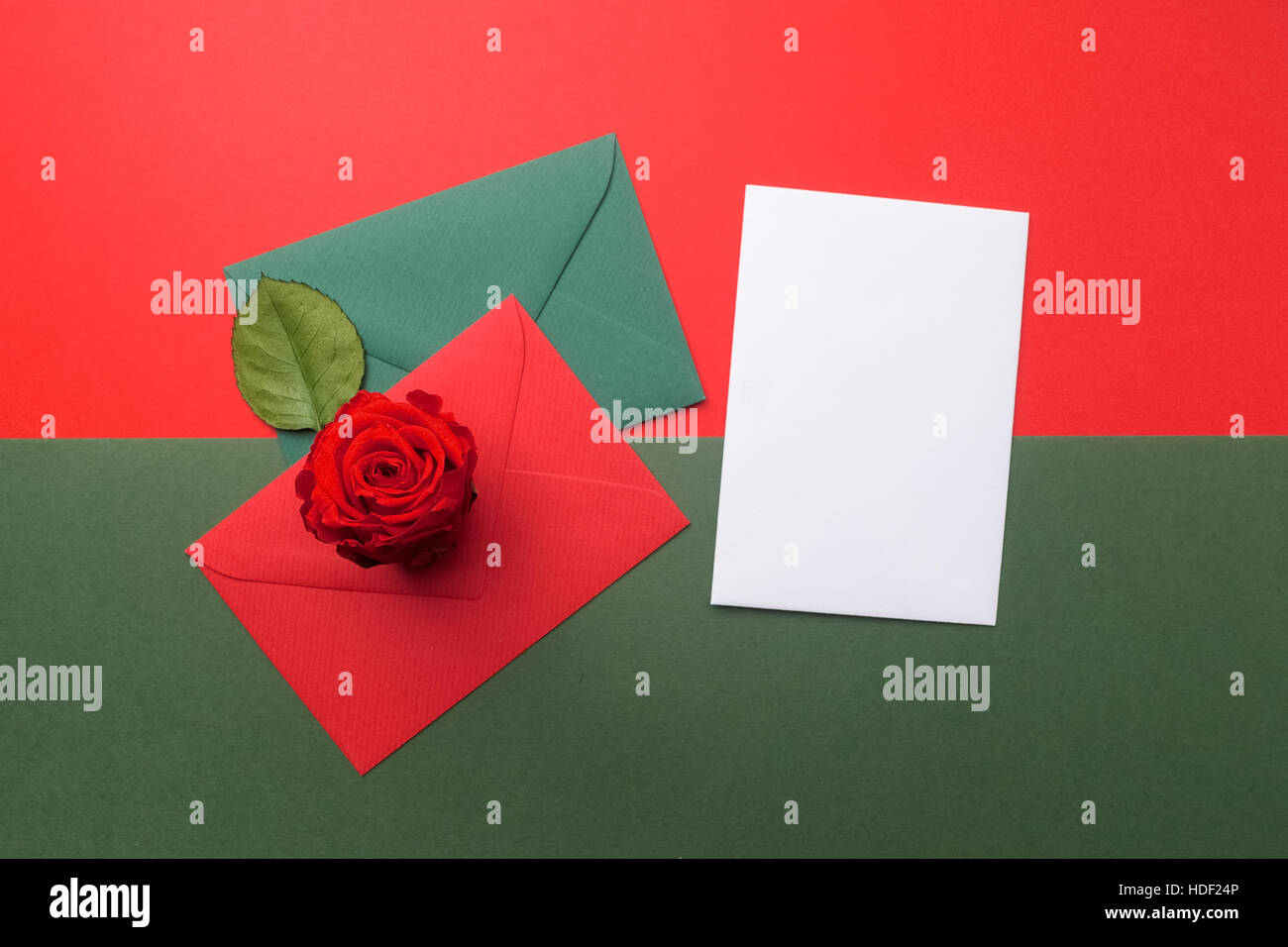 Red and green envelopes on christmas holiday background flat lay stock