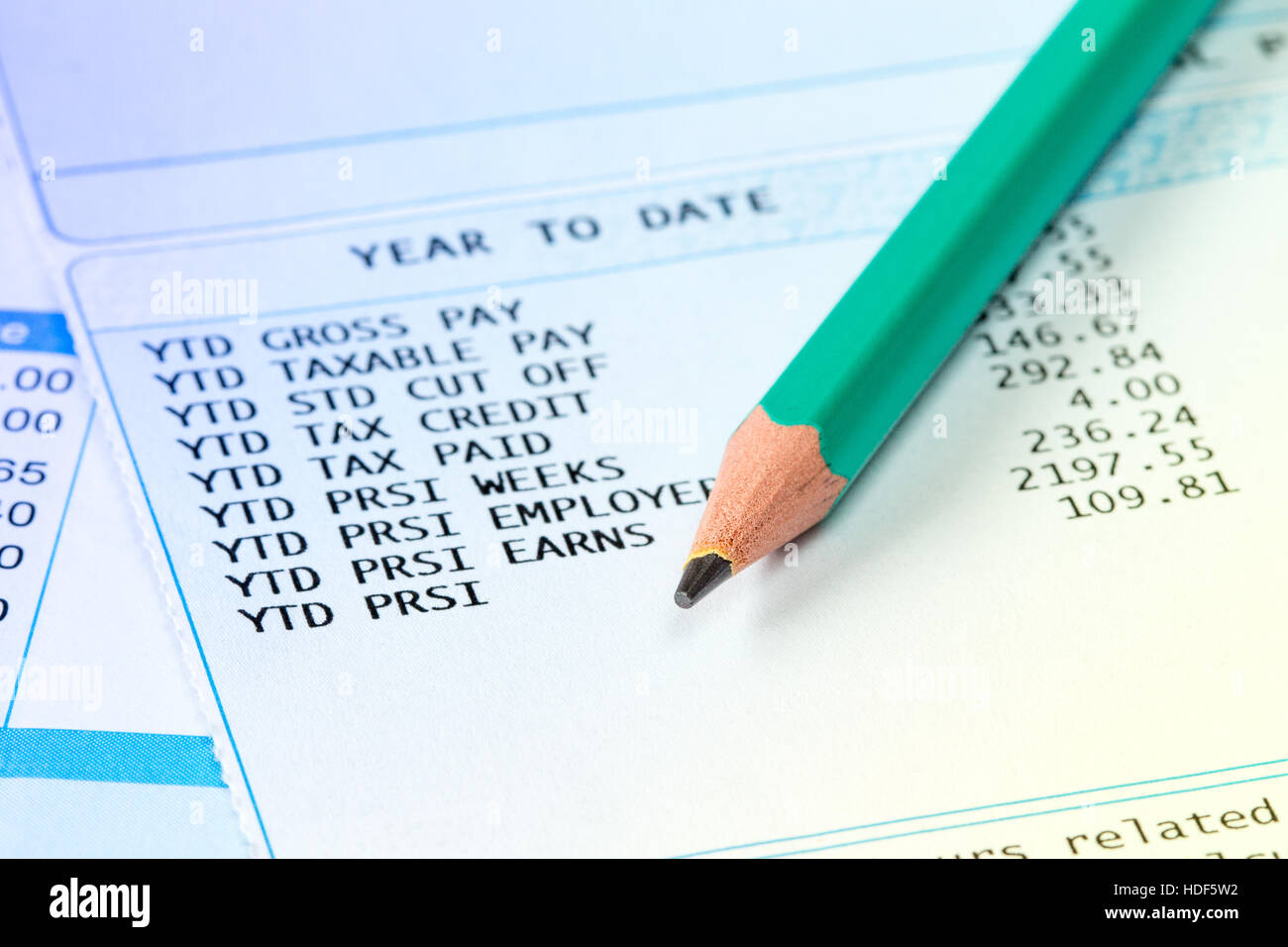 Statement of payroll details with a pencil. Financial accounting concept. Stock Photo