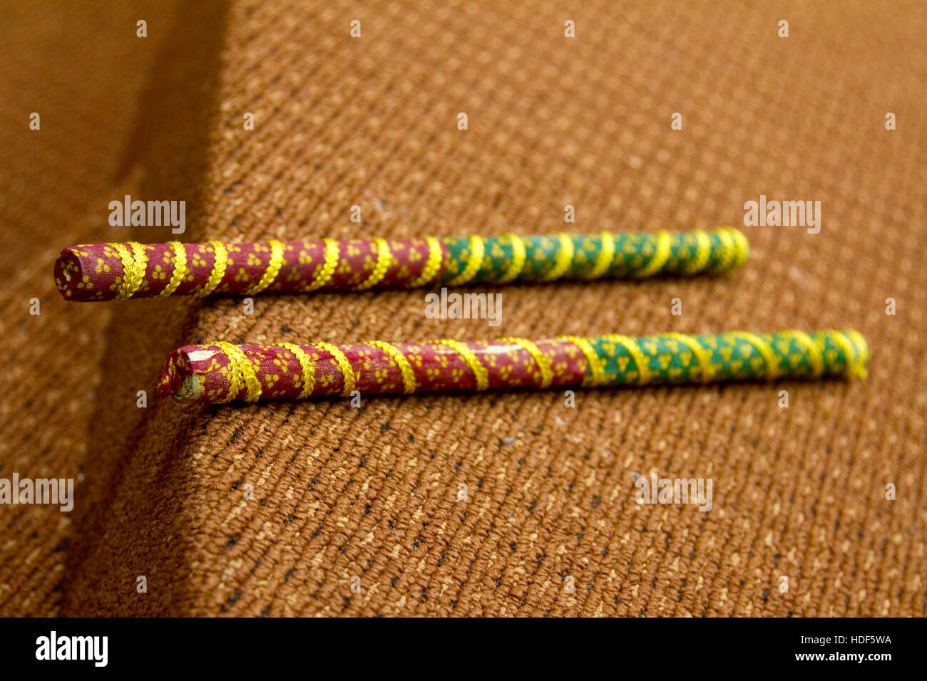 2 Dandiya sticks next to each other. Dandiya is the traditional folk dance of the state of Gujarat in India. (shallow depth of field image) Stock Photo