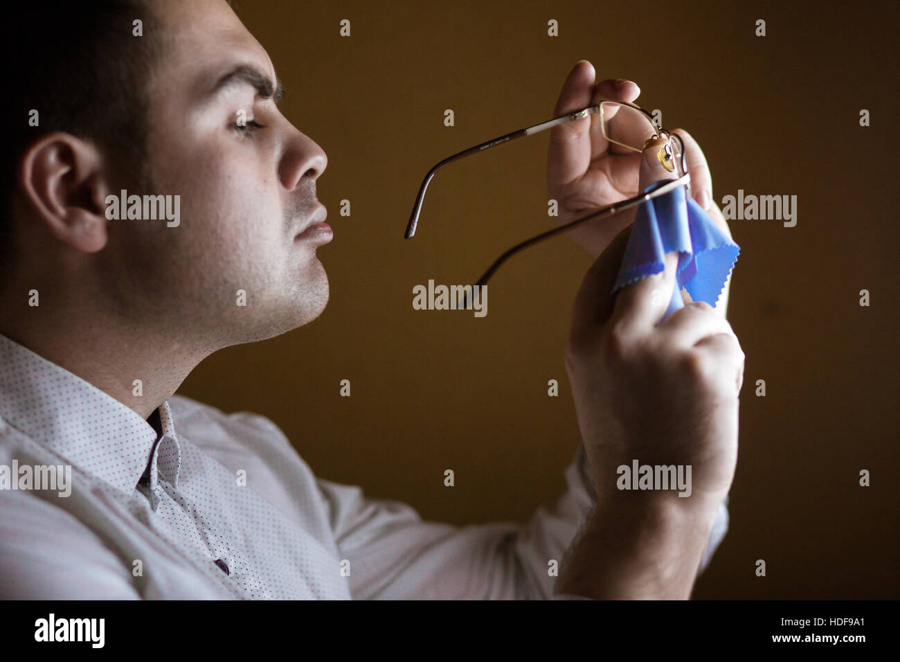 Man wipes with a softie of  lens  computer glasses Stock Photo