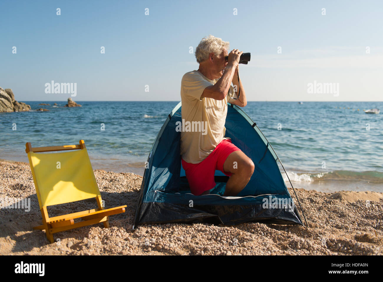 beach spy Man with spy glasses camping at the beach Stock Photo - Alamy