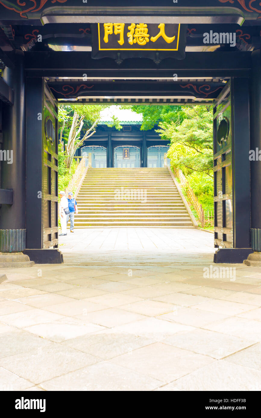 Stairs seen through open entrance doors to historic Yushima Seido, a Confucian temple in Tokyo, Japan. Vertical Stock Photo