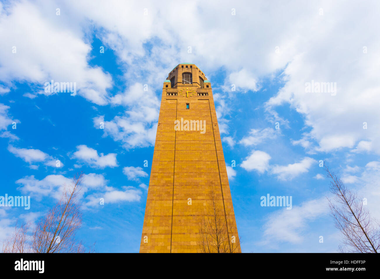 Low angle view of the clock tower on campus of Daejeon Institute of Science and Technology on a sunny blue sky day, South Korea Stock Photo
