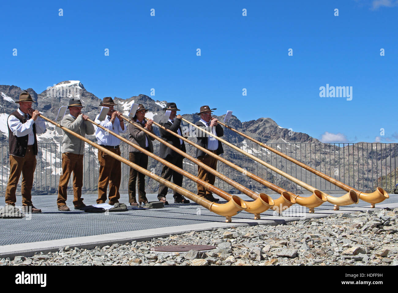 Six Swiss alphorn blowers on top of a Swiss mountain top Stock Photo