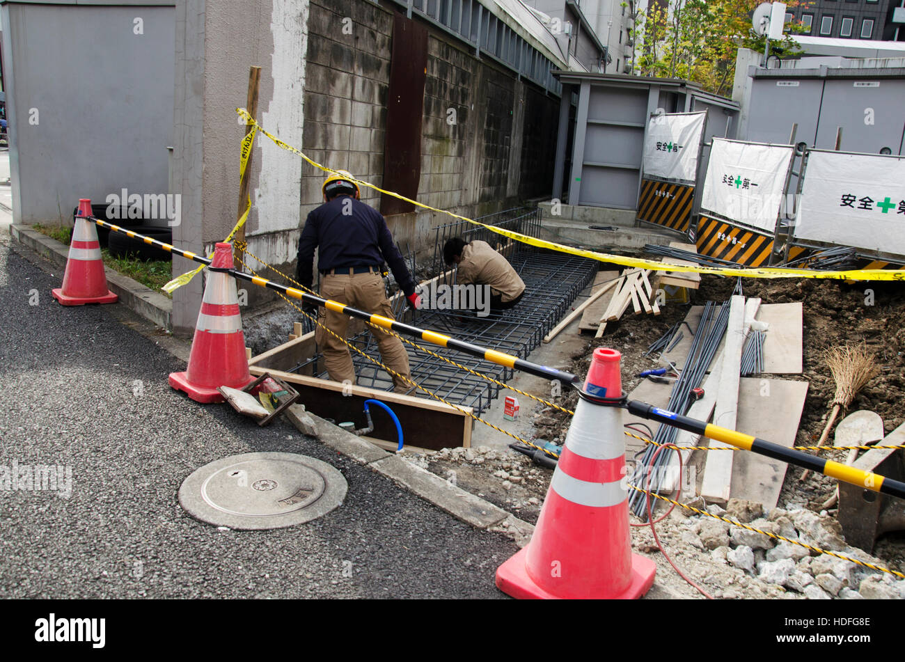 Japanese people in construction site working and repair surface of road