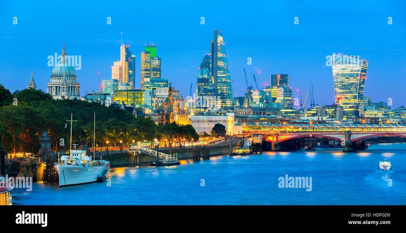London cityscape at dusk with urban buildings over Thames River Stock Photo