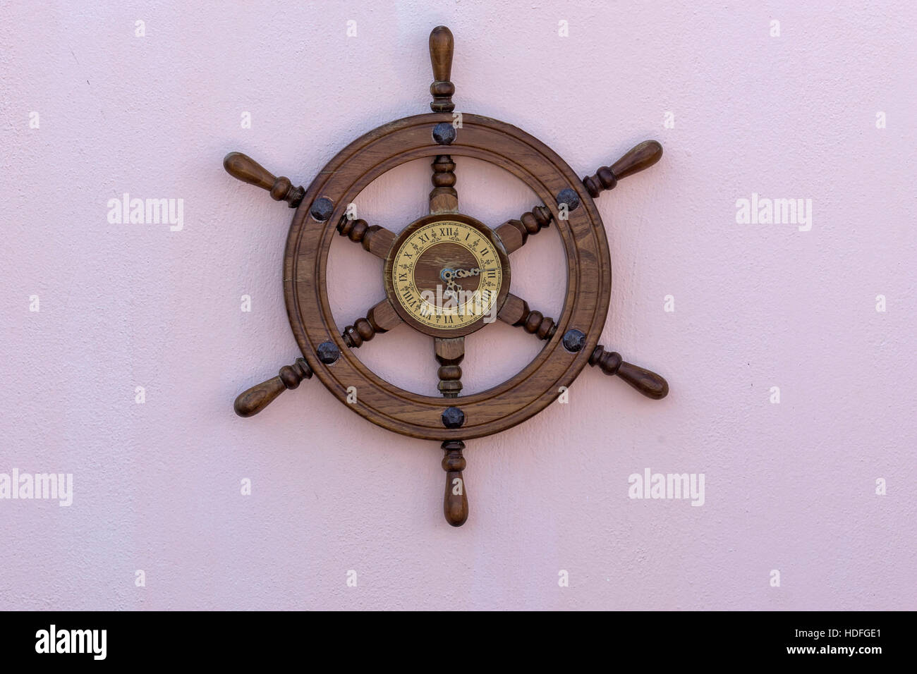 Wall clock made from boat steering hanging on the wall Stock Photo