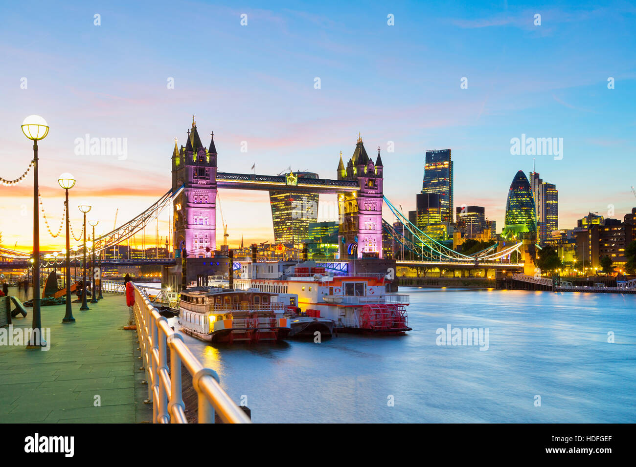 A beautiful dusk-time view of Tower Bridge and the River Thames in London, with financial district in background Stock Photo