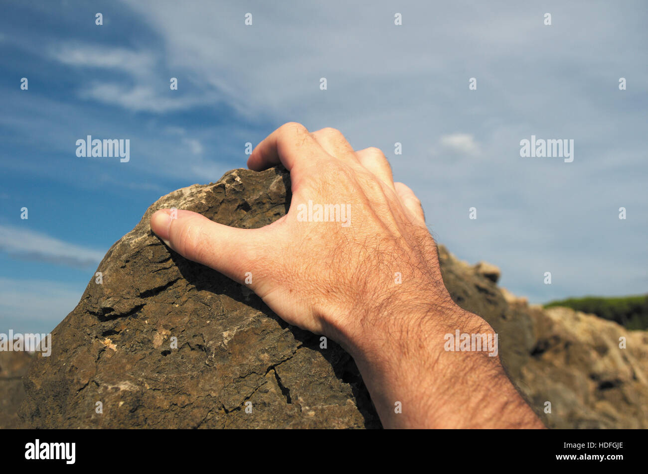 climber gripping rock Stock Photo