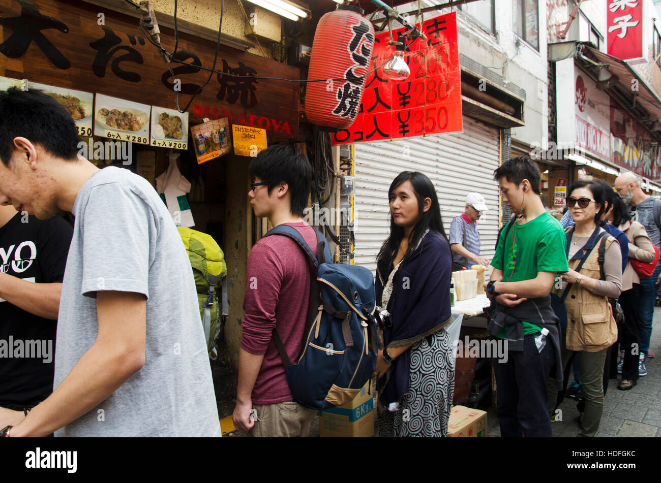 Japanese people and travelers foreigner standing queue buy takoyaki is