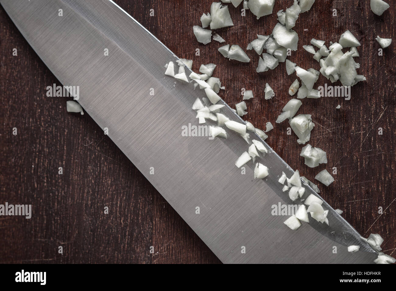 Chopped onion with knife on the wooden board top view Stock Photo