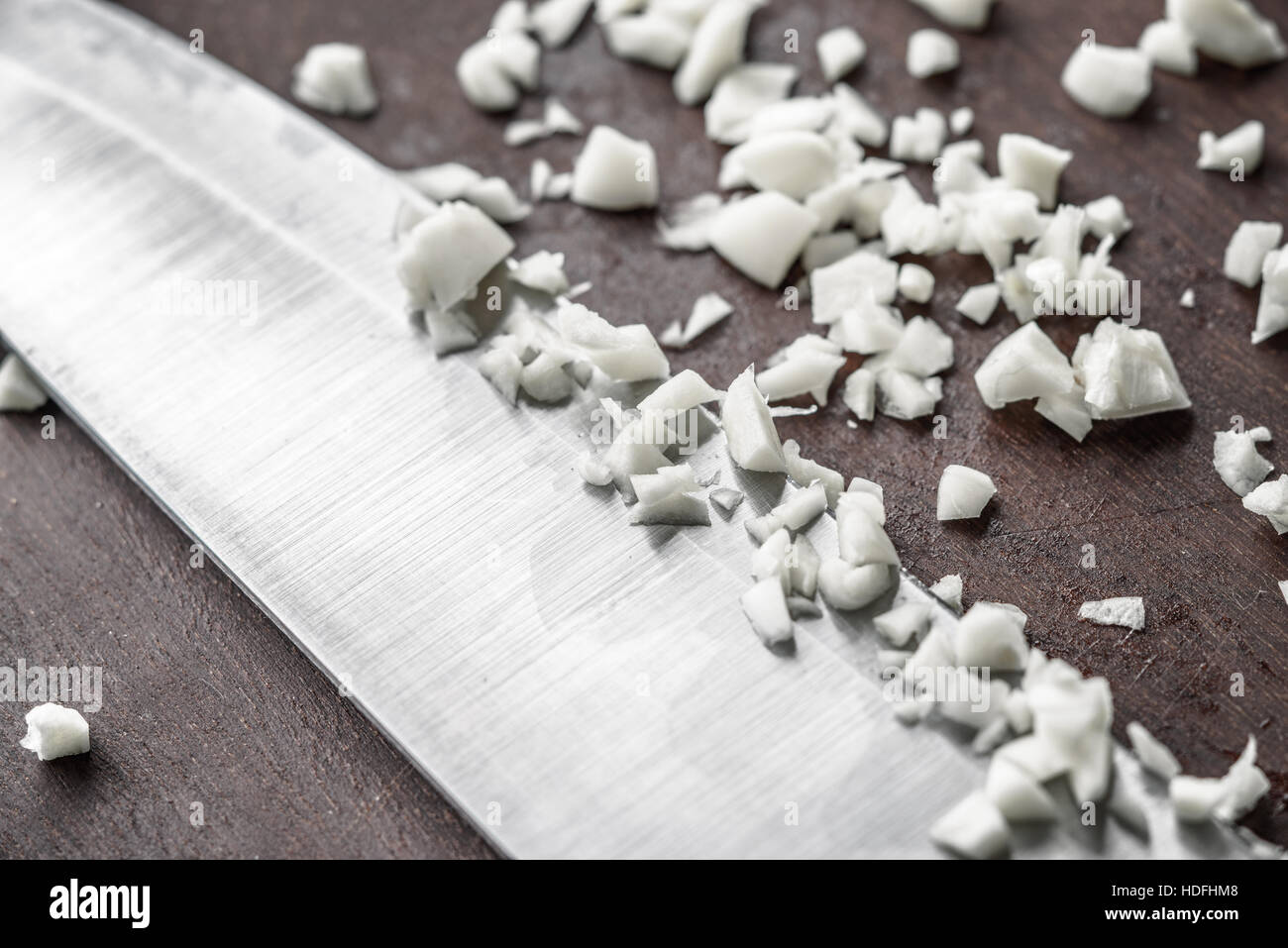 Chopped onion with knife on the wooden board Stock Photo