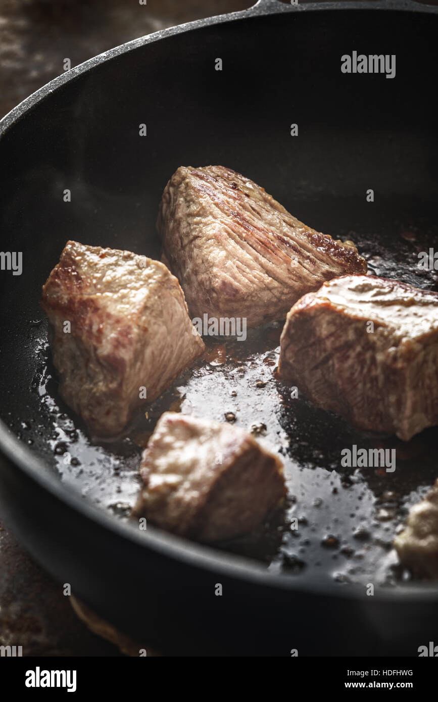 Fried angus beef in the hot pan vertical Stock Photo