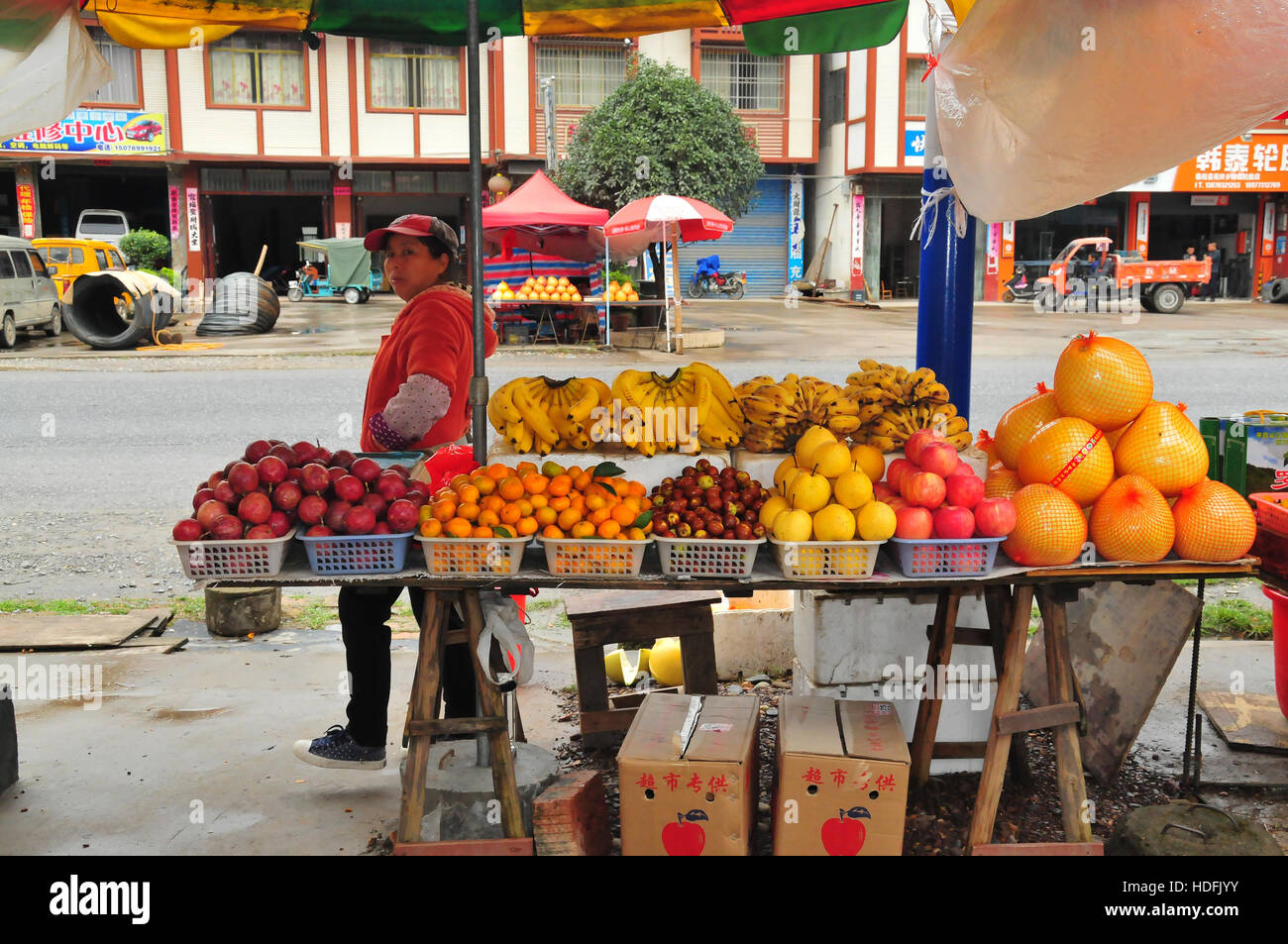 Vendors often sell food, such as fruit, on stands in Guilin, China. Stock Photo