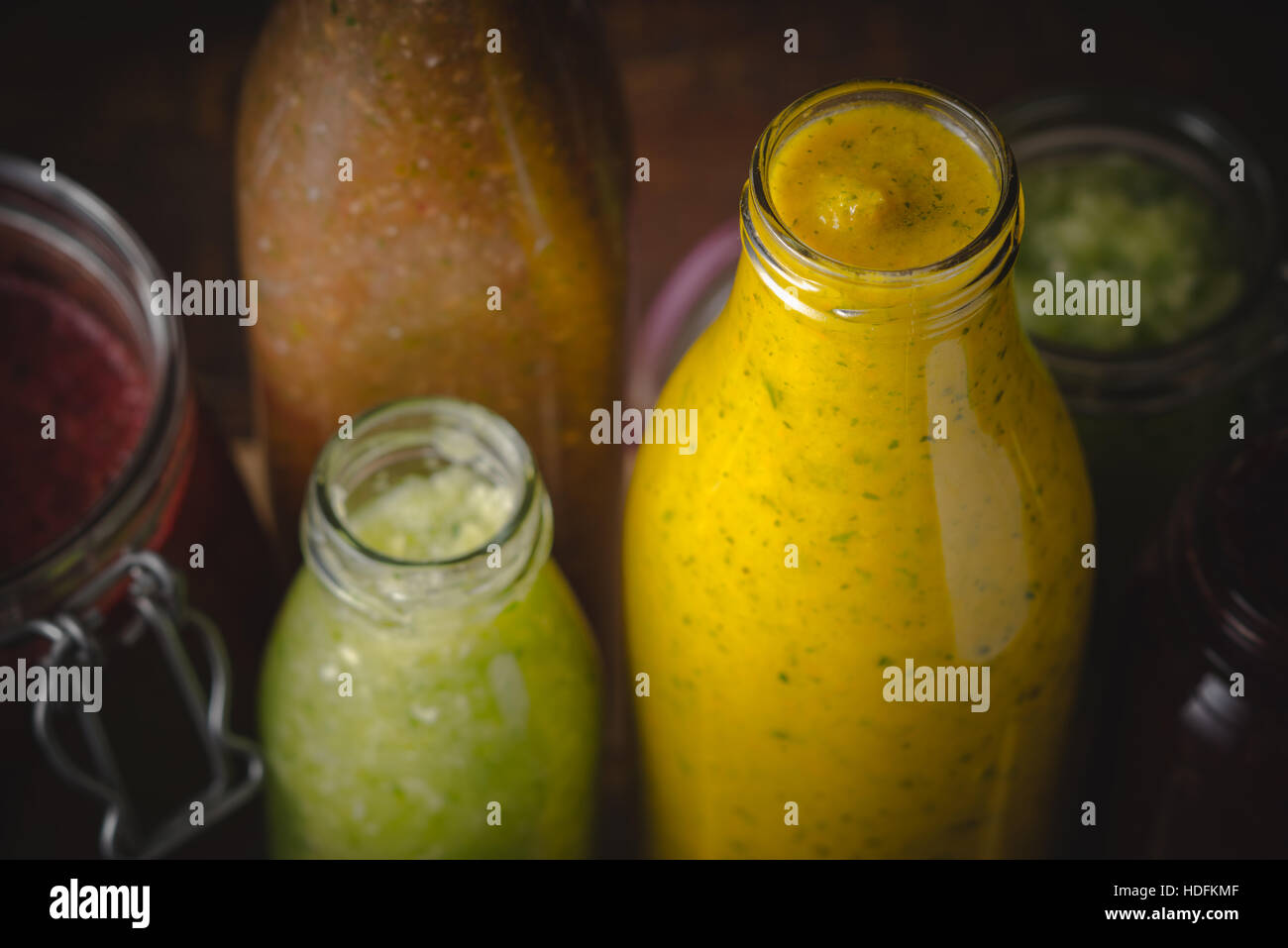 Jars and bottles with different smoothie top view Stock Photo