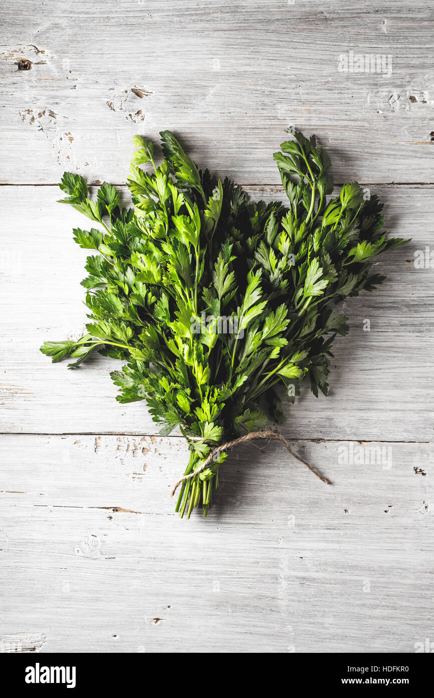 Bunch of parsley on the white wooden table vertical Stock Photo Alamy