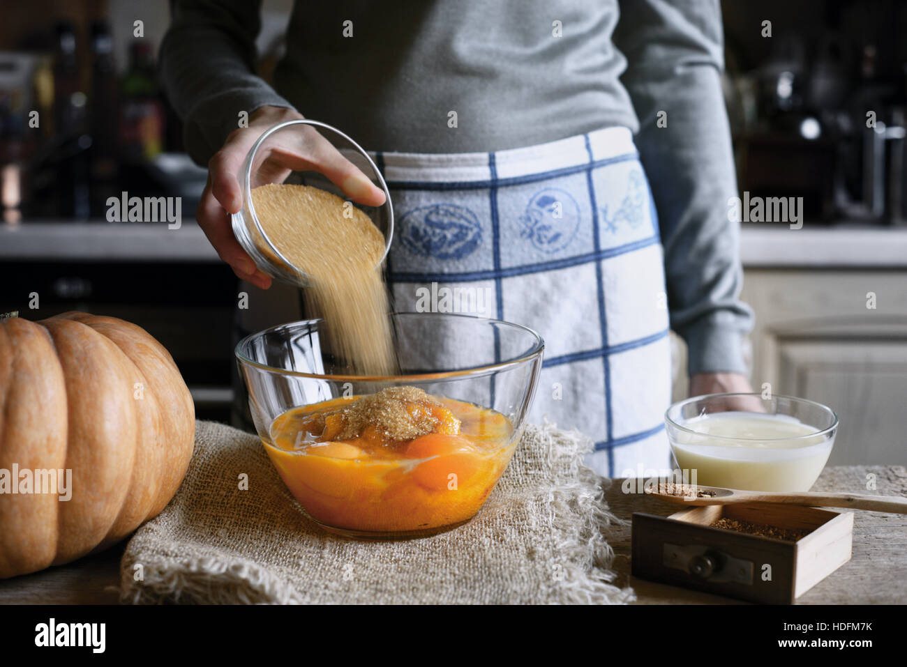 Adding sugar in the dough for pumpkin dump cake horizontal Stock Photo