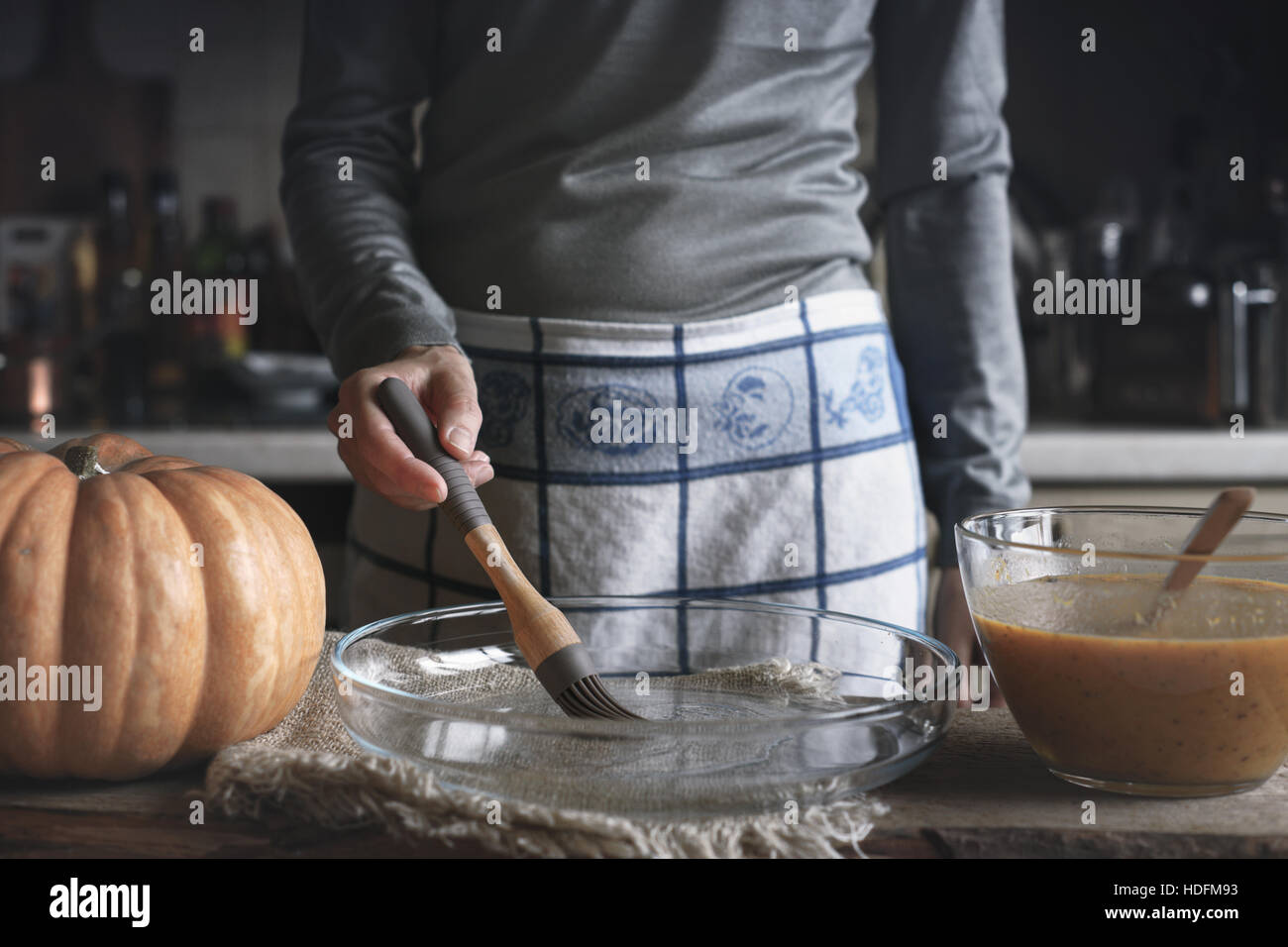 Oiling the backing dish for pumpkin dump cake Stock Photo