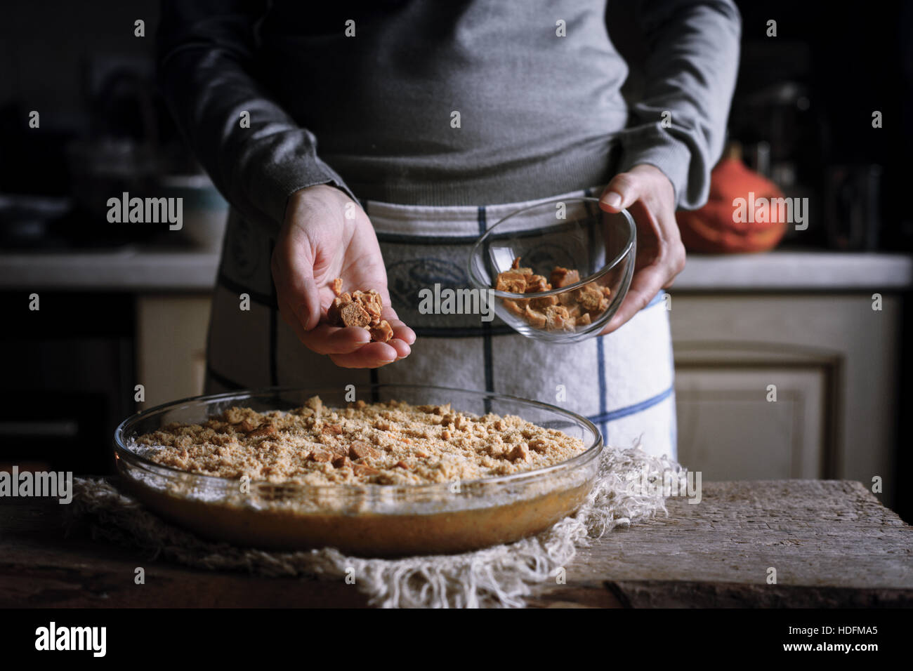 Adding toffee in the dough for pumpkin dump cake Stock Photo