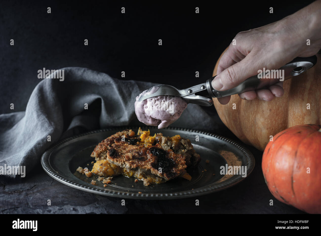 Putting ice cream on the pumpkin dump cake  horizontal Stock Photo
