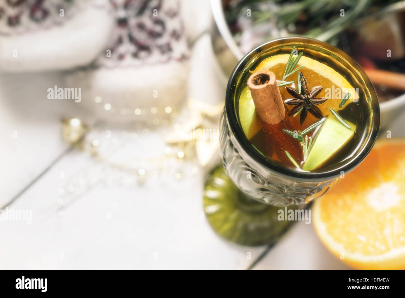 Mulled wine with different spices in the green glass top view Stock Photo