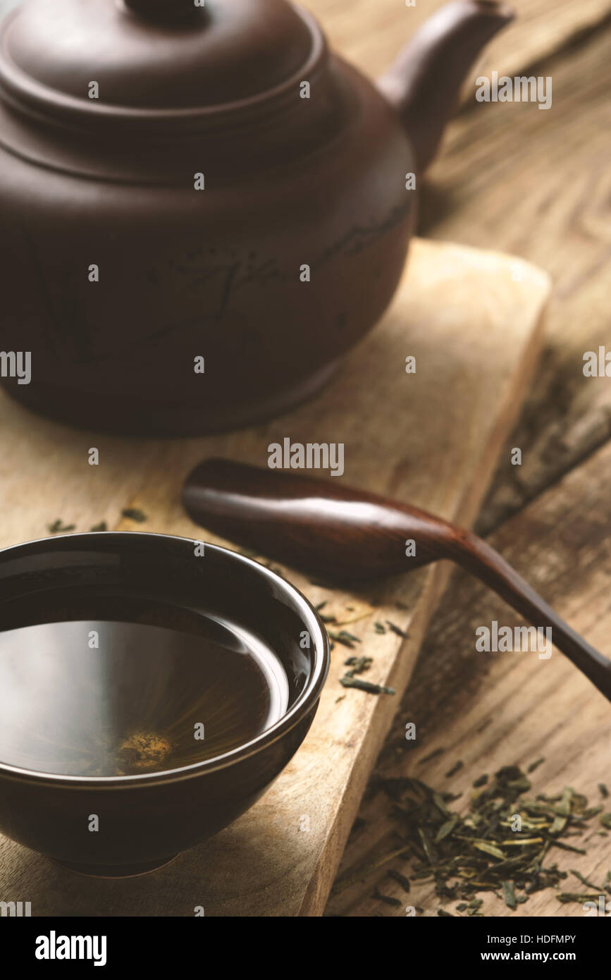 Chinese bowl with tea on the wooden table vertical Stock Photo