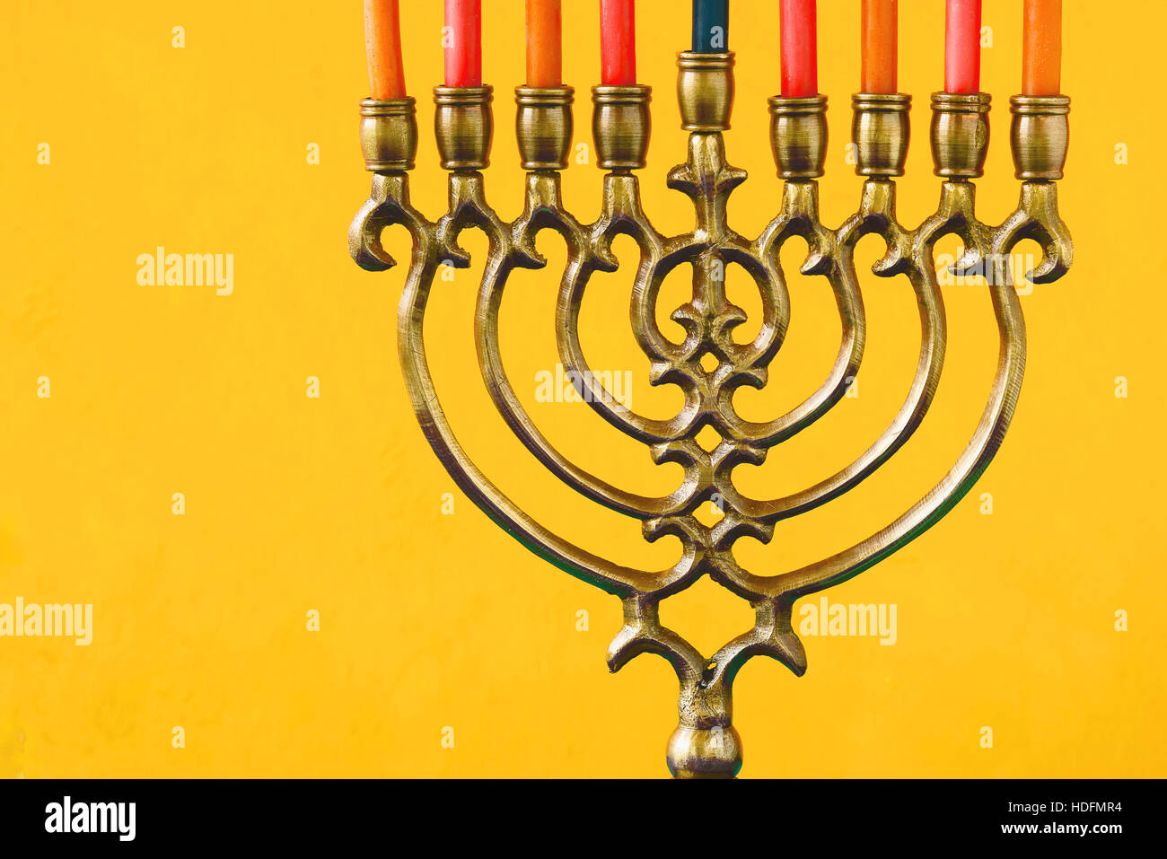 Hanukkah menorah with candles on the yellow background horizontal Stock